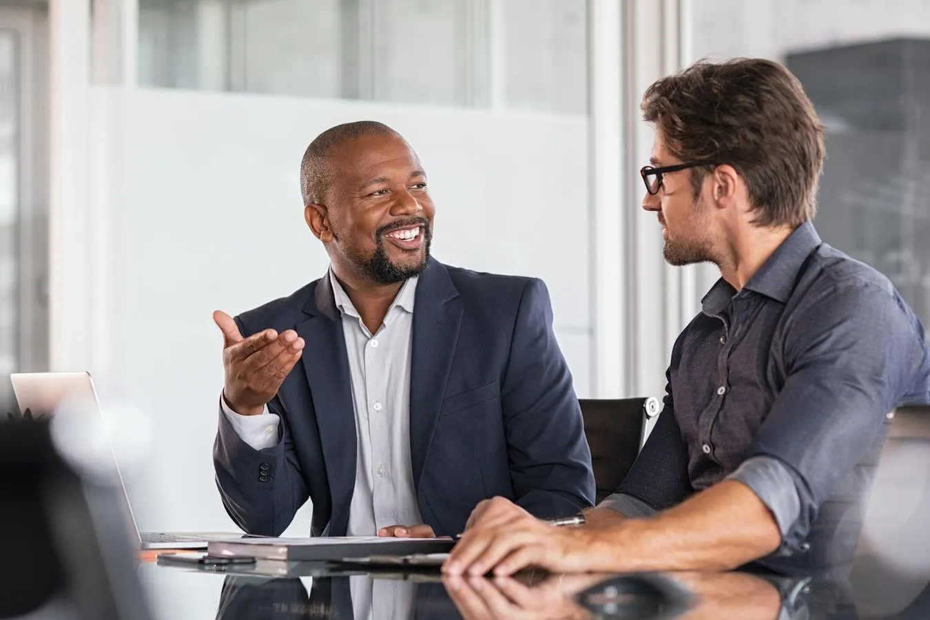 Two people discussing a proposal in a meeting